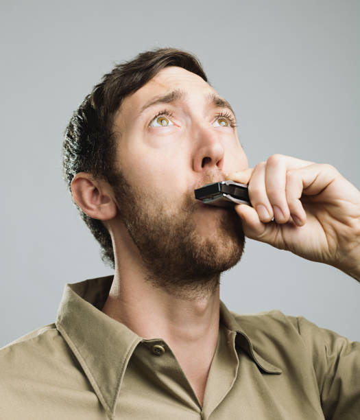 istock Close-up of man playing harmonica 640215952