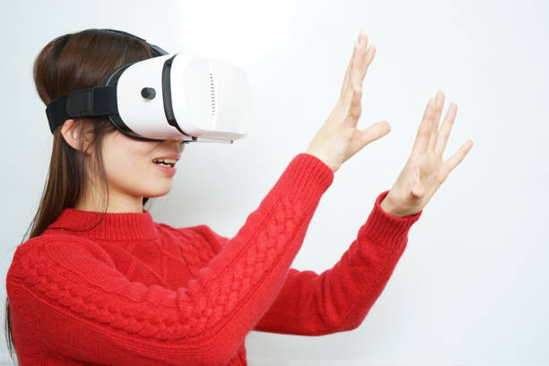 istock Young attractive Japanese woman using VR-headset glasses 640216282
