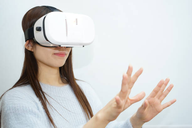 istock Young attractive Japanese woman using VR-headset glasses 640216292