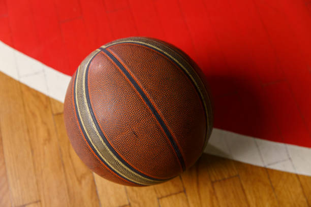 istock Basketball ball on court floor 640217714