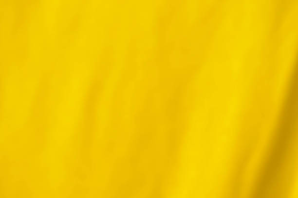 Sheet drying on a clothes line A yellow sheet drying outdoors on a washing line, will make a good textured background with the creases and folds in the material. mustard yellow fabric stock pictures, royalty-free photos & images