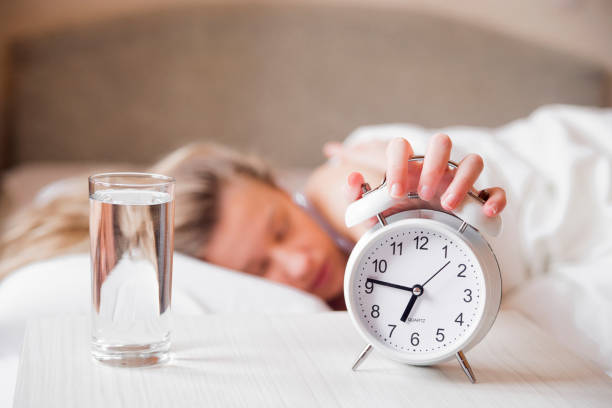 istock Woman's hand off the alarm clock, 7:15 am 640220580