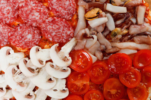 Cooking traditional Italian delicious pizza, with mushrooms, seafood and salami.