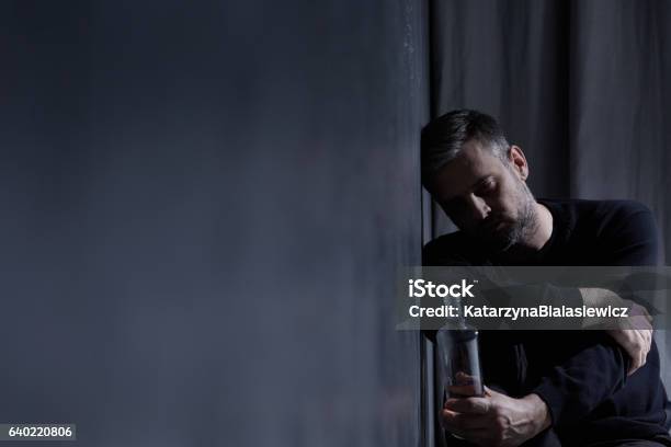 Man Holding Bottle Of Alcohol Stock Photo - Download Image Now - Detox, Alcohol Abuse, Alcohol - Drink