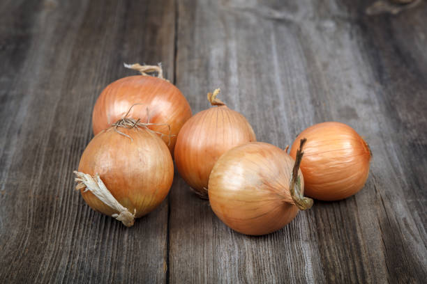 istock Fresh onions on a wooden background 640220834