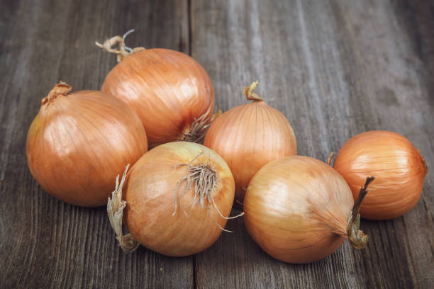 istock Fresh onions on a wooden background 640220916