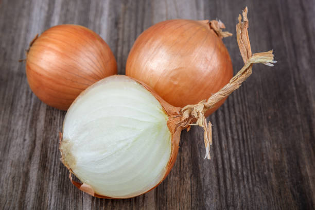 istock Fresh onions on a wooden background 640221322