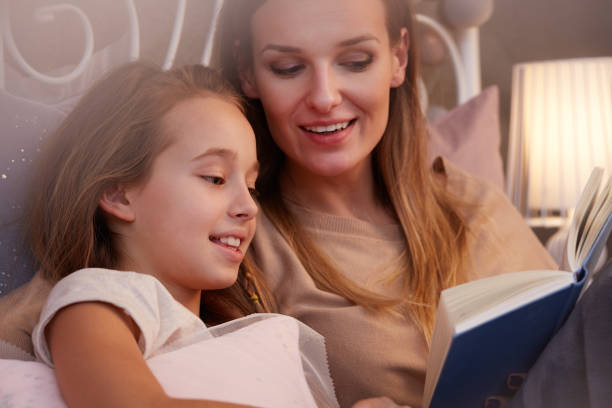 istock Mother reading to daughter 640221404