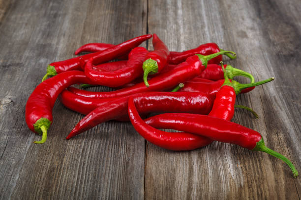 istock Red hot peppers on wooden background 640223266