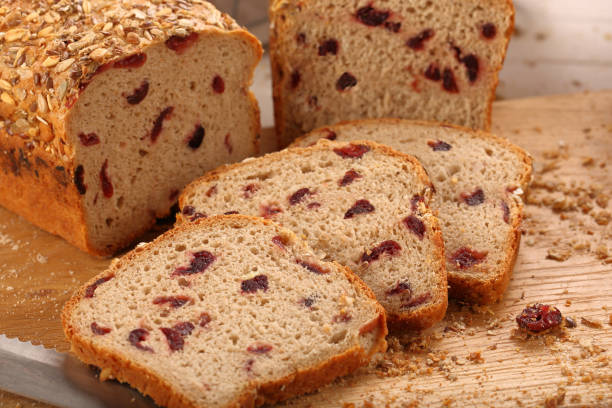istock Whole grain bread with cranberry on a wooden board 640227010