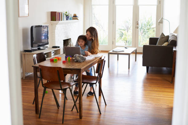 istock Mother And Daughter Using Laptop At Home Together 640227156