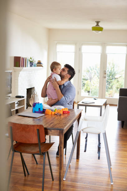 istock Father Sits At Table And Plays With Baby Son At Home 640227200