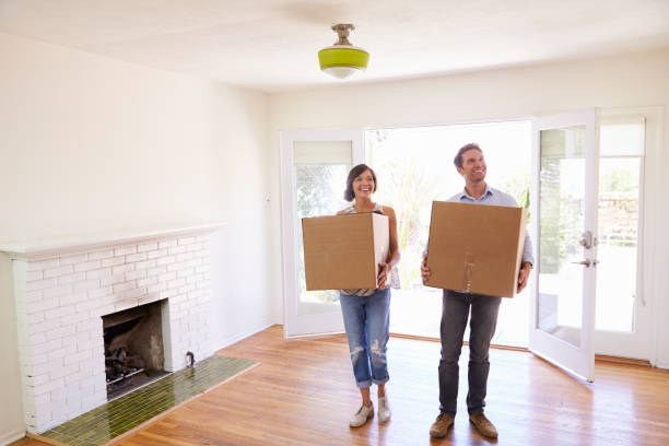 istock Couple Carrying Boxes Into New Home On Moving Day 640228014