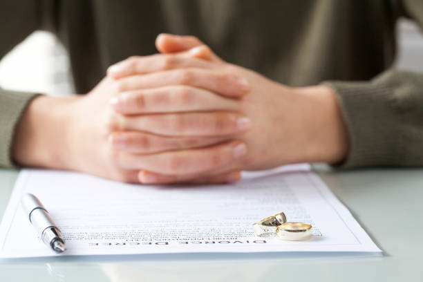 istock Wife signs divorce decree form with ring 640228026
