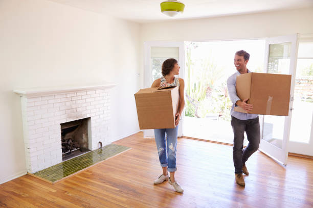 istock Couple Carrying Boxes Into New Home On Moving Day 640228110