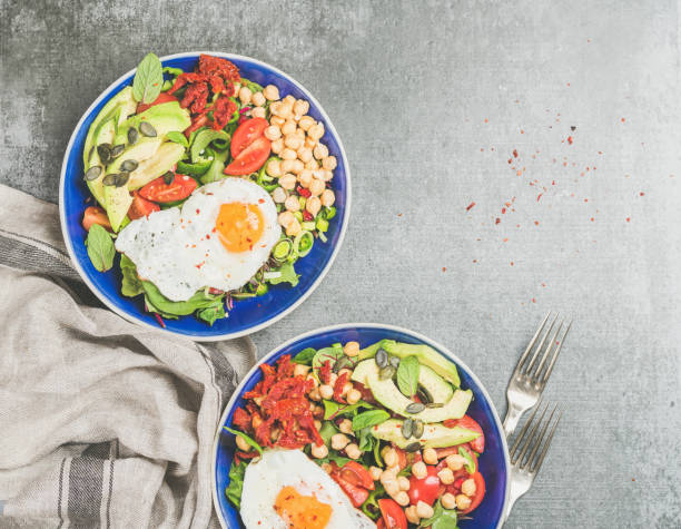istock Healthy breakfast with fried egg, chickpea sprouts, seeds in bowls 640228438