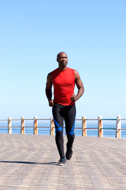 istock Muscular african man running on seaside promenade 640229108