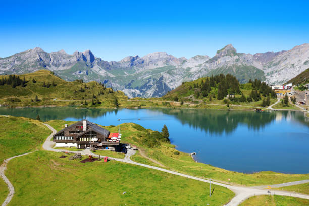 Aerial view of scenic mountain landscape with a mountain restaurant at Trübsee lake in Engelberg Switzerland on a beautiful summer day.
