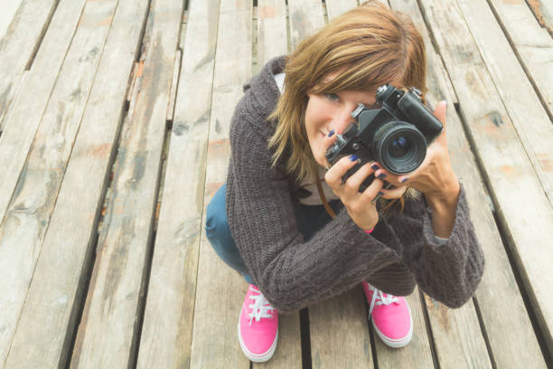 istock Young girl with a retro camera. 640230916