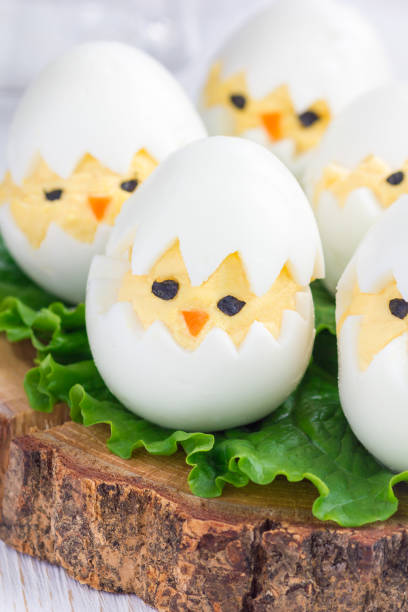 istock Chicken in nest, deviled eggs on wooden board, vertical 640231436