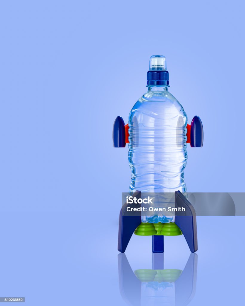 Water bottle in the form of a rocket on blue Water bottle in the form of a rocket on blue background Rocketship Stock Photo