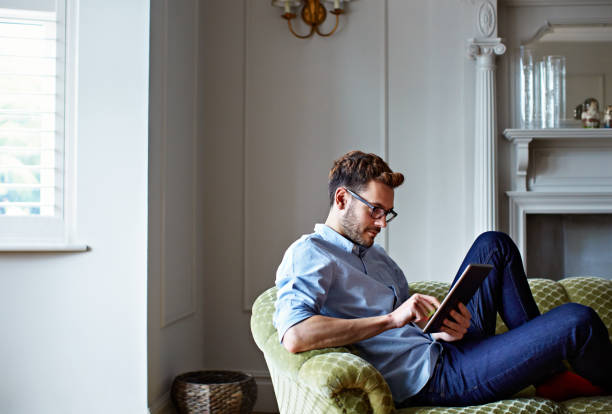 istock Chilling at home with his tablet 640232788