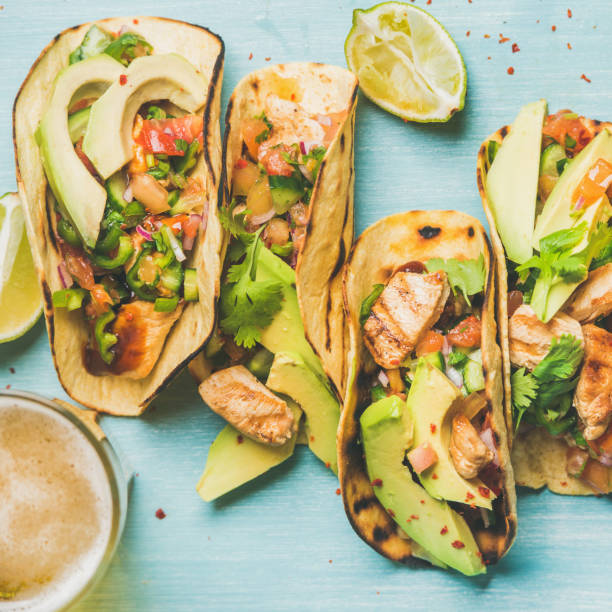 istock Healthy corn tortillas and beer over blue background, square crop 640233980
