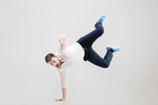 istock young happy businessman with beard in shirt break dancing on 640234206