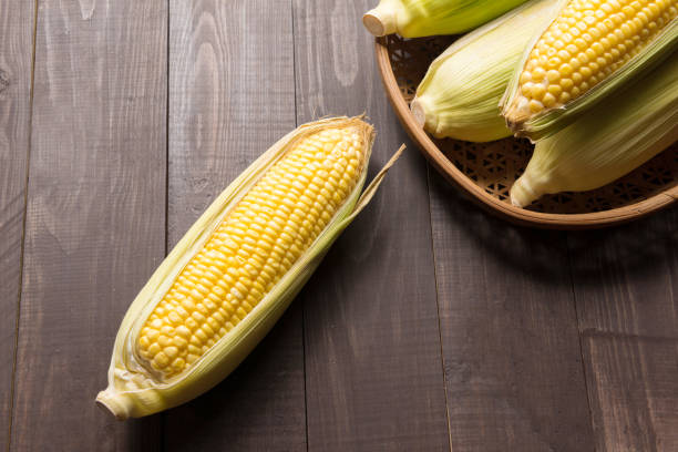 istock Fresh organic yellow sweet corn on wooden table 640236860
