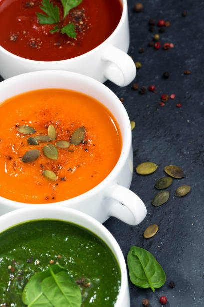 istock assortment of fresh vegetable cream soup on a black background 640237174