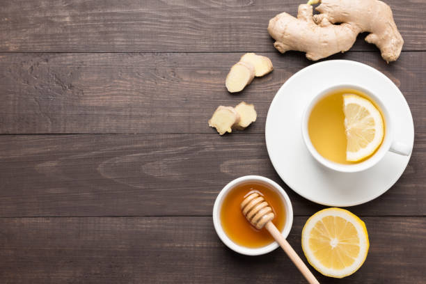 istock Cup of ginger tea with lemon and honey on table. 640237322