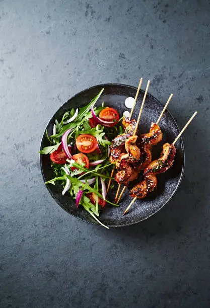 Satay chicken skewers with salad