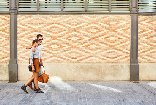Shot of an affectionate young couple walking together in the city