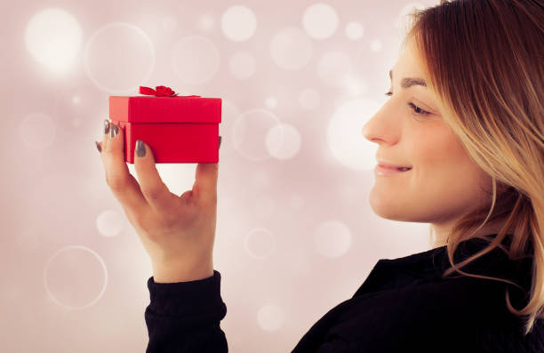 istock Happy young woman with gift for Valentines Day 640239212