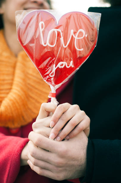 istock Beautiful young lovers holding a big red heart 640240458