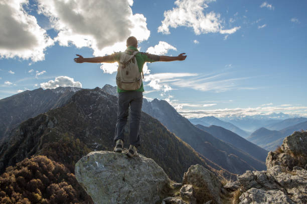 istock Hiker celebrates success on mountain top 640240786