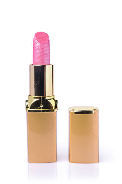 Pink lipstick in opened gold case for make up isolated on white
