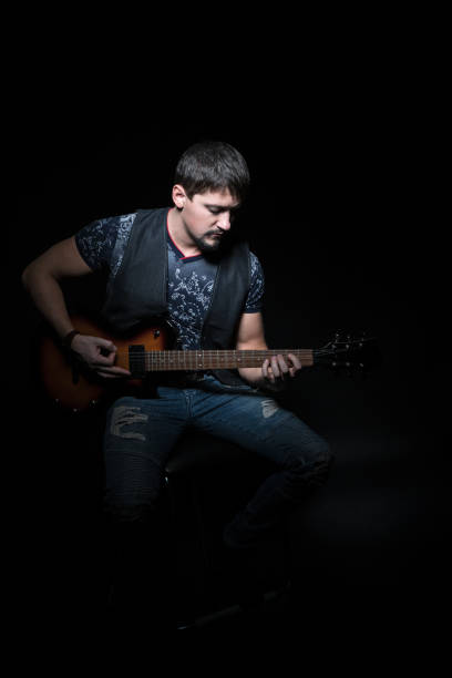 istock Bearded guitarist with an electric guitar 640242676