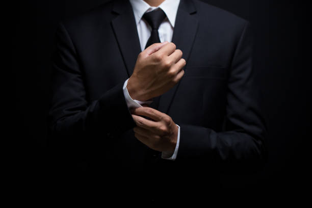 Businessman adjusting his cufflinks Businessman adjusting his cufflinks man adjusting tie stock pictures, royalty-free photos & images