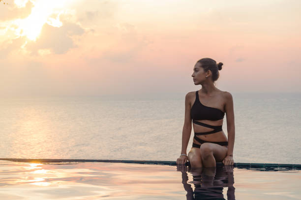 istock Woman at the infinity pool on sunset 640243678