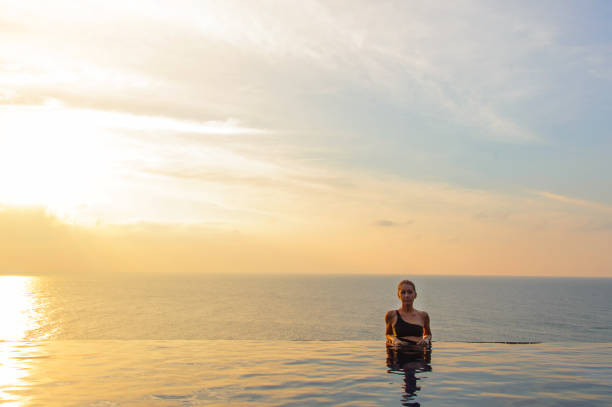 istock Woman at the infinity pool on sunset 640243712