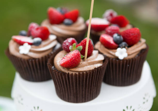 istock Beautiful cupcakes with berries closeup on banquet table. 640244366