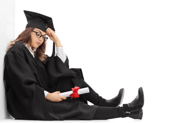 istock Depressed graduate student with a diploma sitting on the floor 640245200