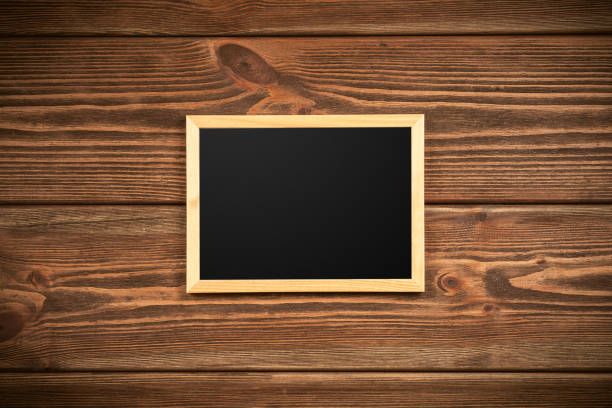 istock Picture frame on a wooden wall 640248356