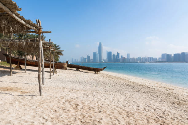 View to Abu Dhabi skyline from the beach, UAE View to Abu Dhabi skyline from the beach, United Arab Emirates corniche stock pictures, royalty-free photos & images