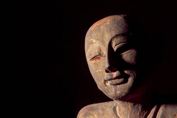 istock Traditional Aged Carving of a Buddhist Monk 640248908