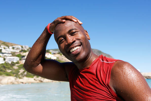 istock Cheerful afro african guy at the beach after swim 640249326