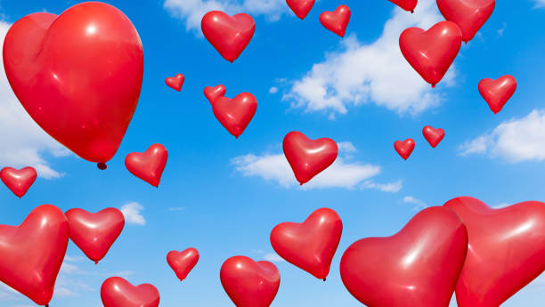 istock Heart Shape Balloons into blue sky 640252086