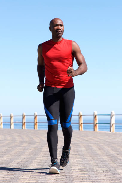 istock Confident african man running on seaside promenade 640252172