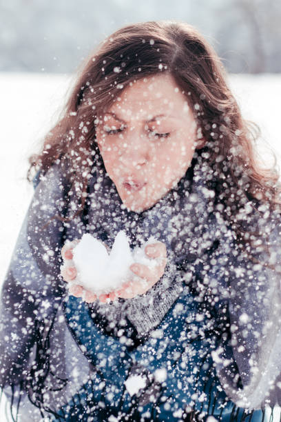 istock Cute young woman playing with snow 640252942